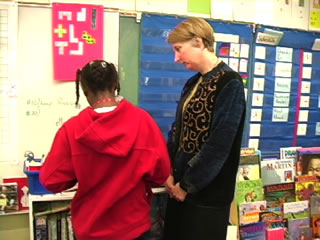 teacher talking with student