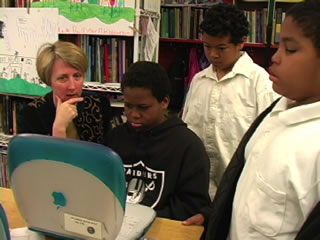teacher and students at computer